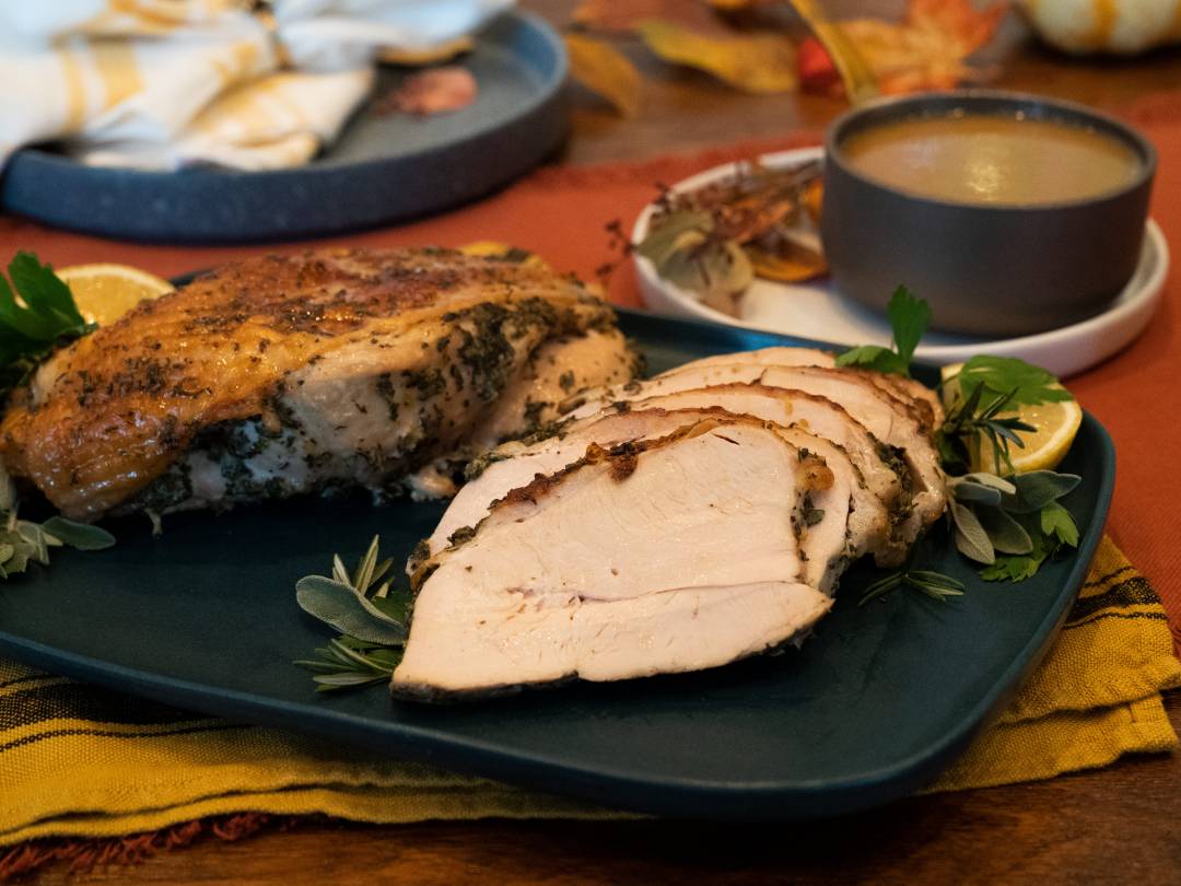 Young and matue men holding tray with homemade roasted turkey over